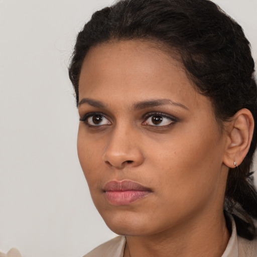 Neutral black young-adult female with long  brown hair and brown eyes