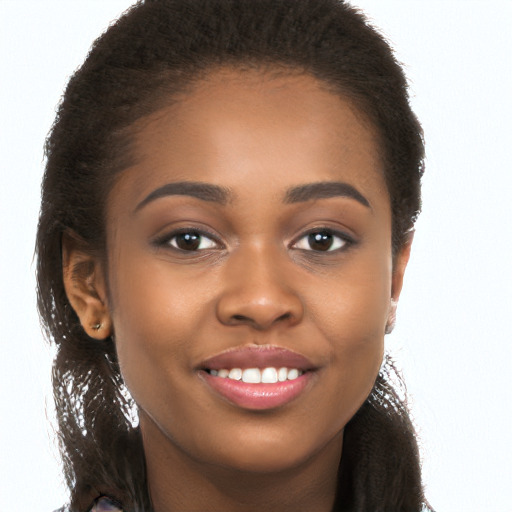 Joyful black young-adult female with long  brown hair and brown eyes