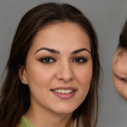 Joyful white young-adult female with long  brown hair and brown eyes