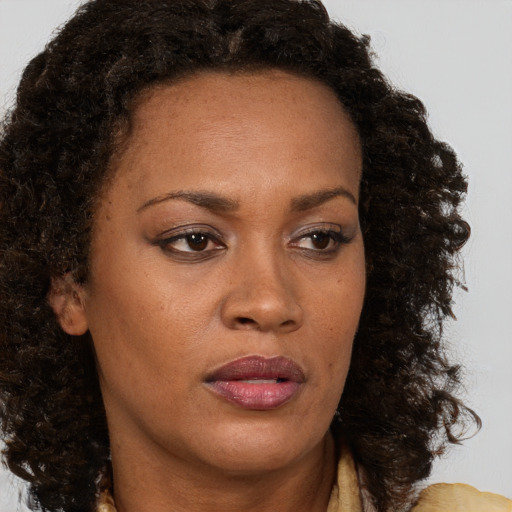 Neutral black young-adult female with medium  brown hair and brown eyes