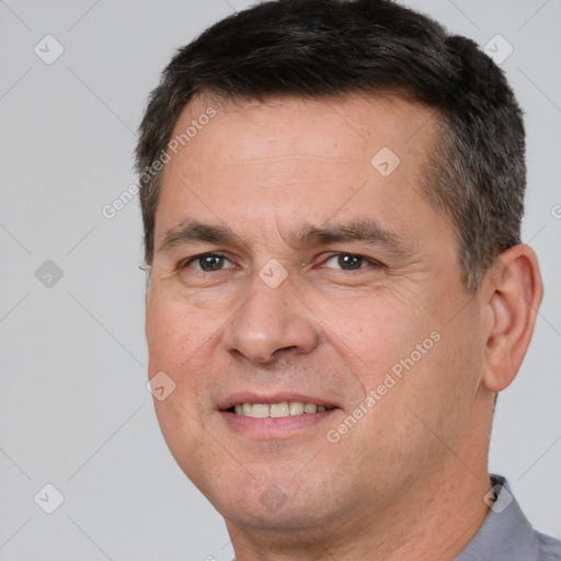 Joyful white adult male with short  brown hair and brown eyes