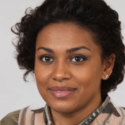 Joyful black young-adult female with medium  brown hair and brown eyes