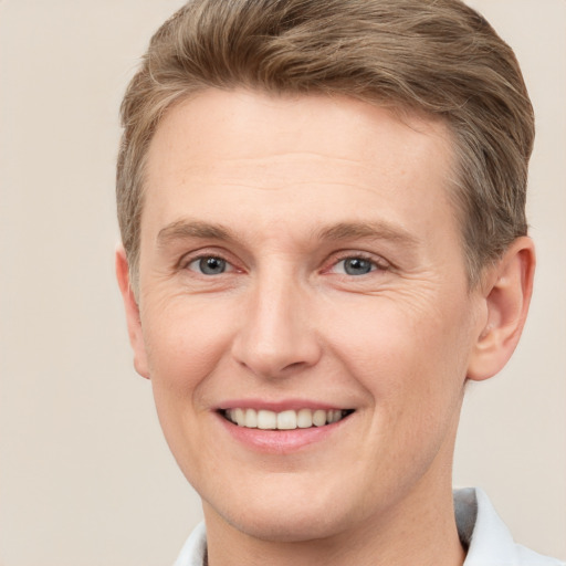 Joyful white adult male with short  brown hair and grey eyes