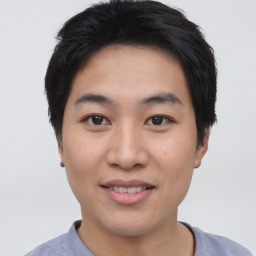 Joyful asian young-adult male with short  brown hair and brown eyes