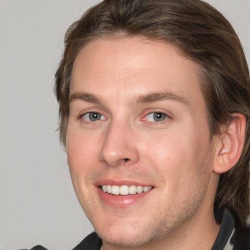 Joyful white adult male with medium  brown hair and grey eyes