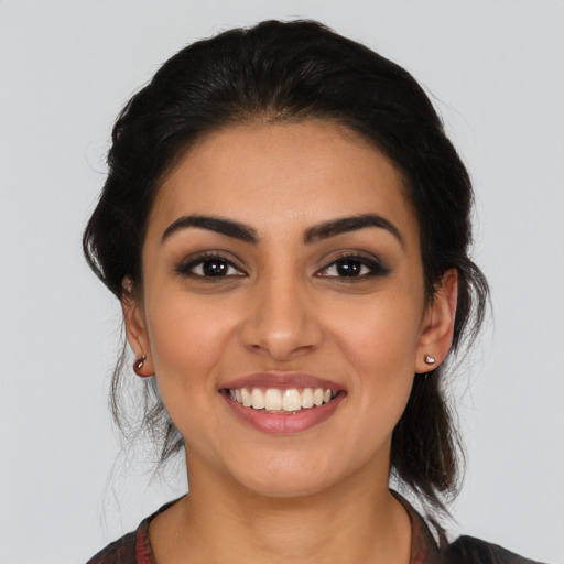 Joyful latino young-adult female with medium  black hair and brown eyes