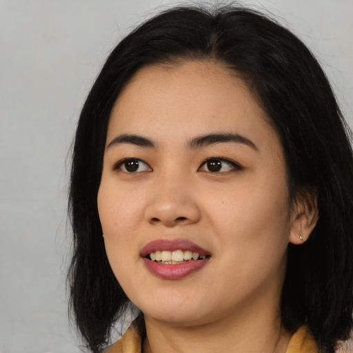 Joyful asian young-adult female with medium  black hair and brown eyes