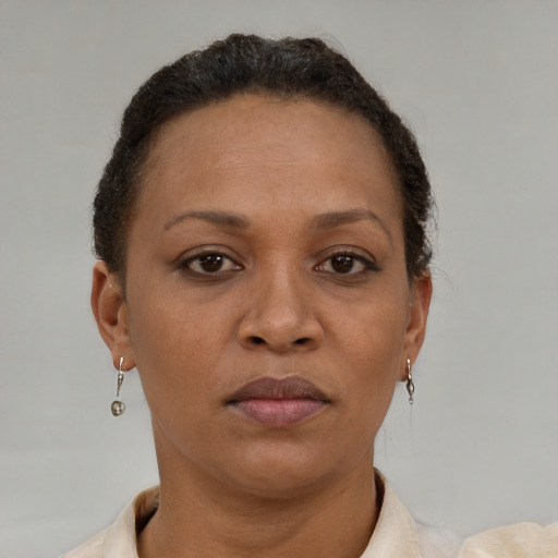 Joyful black adult female with short  brown hair and brown eyes