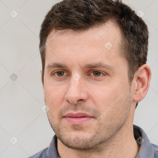 Joyful white adult male with short  brown hair and brown eyes