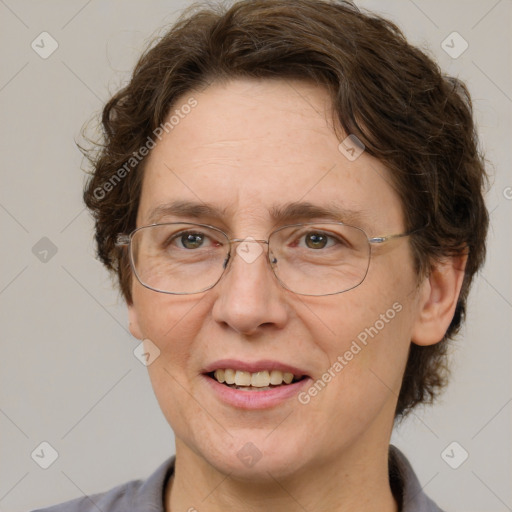 Joyful white adult female with medium  brown hair and green eyes