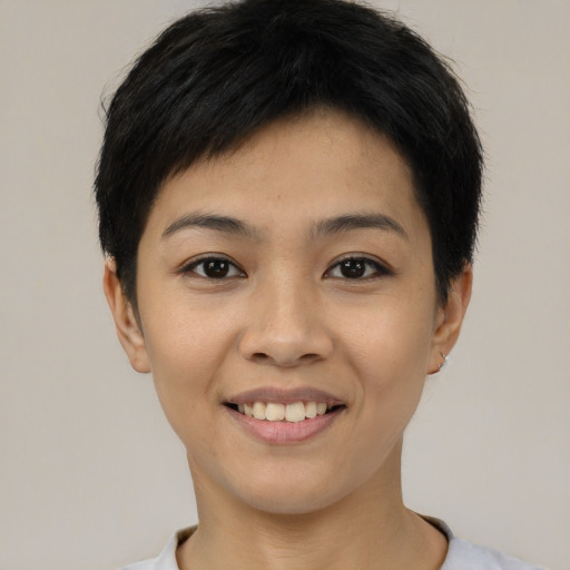 Joyful asian young-adult female with short  black hair and brown eyes