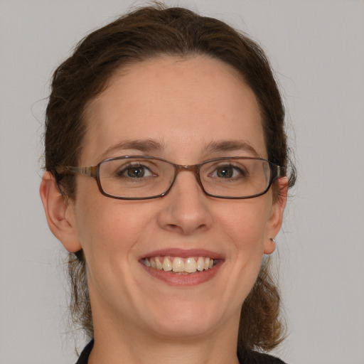 Joyful white adult female with short  brown hair and grey eyes