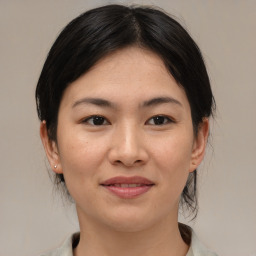 Joyful asian young-adult female with medium  brown hair and brown eyes