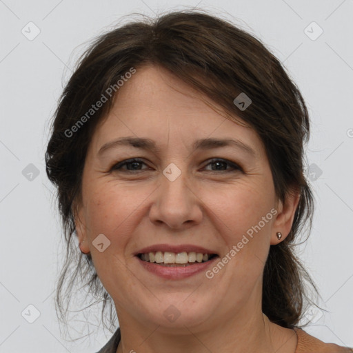 Joyful white adult female with medium  brown hair and brown eyes