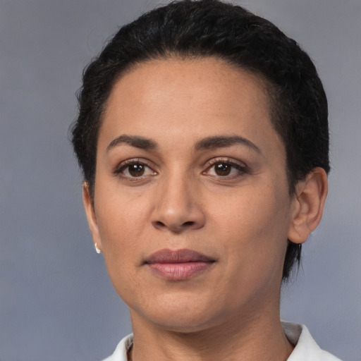 Joyful latino young-adult female with short  black hair and brown eyes