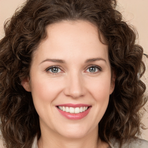 Joyful white young-adult female with medium  brown hair and green eyes