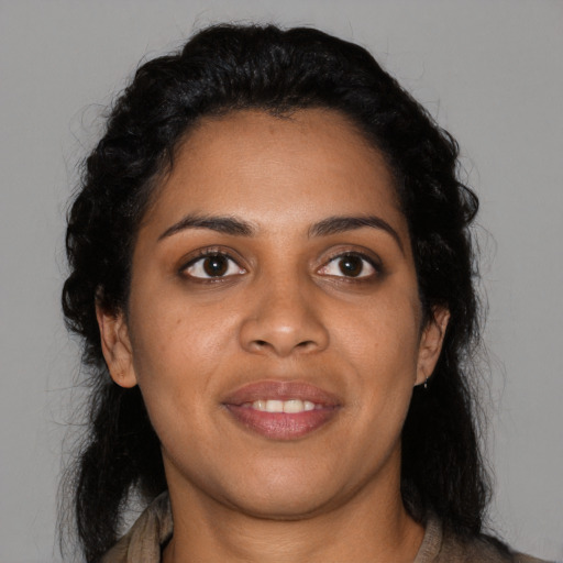 Joyful black young-adult female with medium  black hair and brown eyes