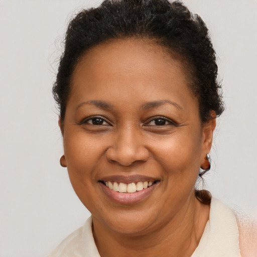 Joyful black adult female with short  brown hair and brown eyes