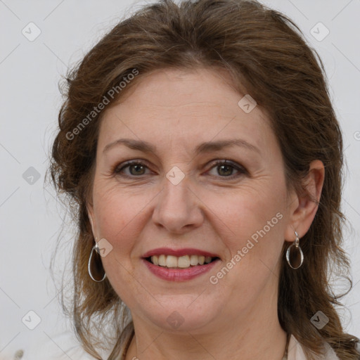 Joyful white adult female with medium  brown hair and grey eyes