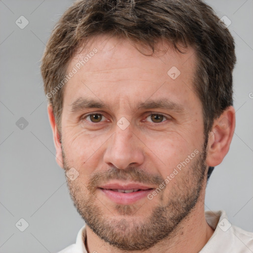 Joyful white adult male with short  brown hair and brown eyes