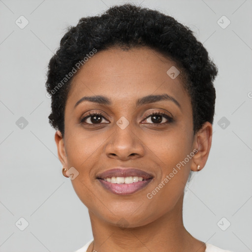 Joyful black young-adult female with short  black hair and brown eyes