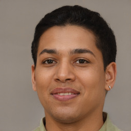 Joyful latino young-adult male with short  brown hair and brown eyes