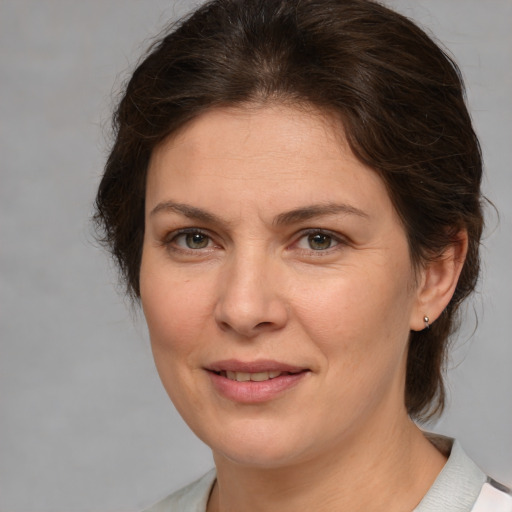 Joyful white adult female with medium  brown hair and brown eyes