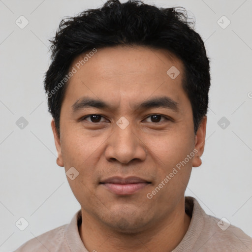 Joyful asian young-adult male with short  black hair and brown eyes