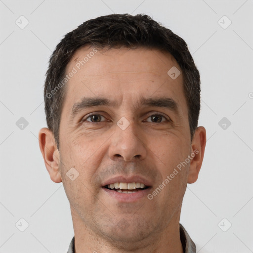 Joyful white adult male with short  brown hair and brown eyes