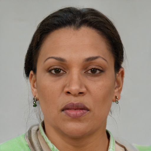Joyful latino adult female with short  brown hair and brown eyes