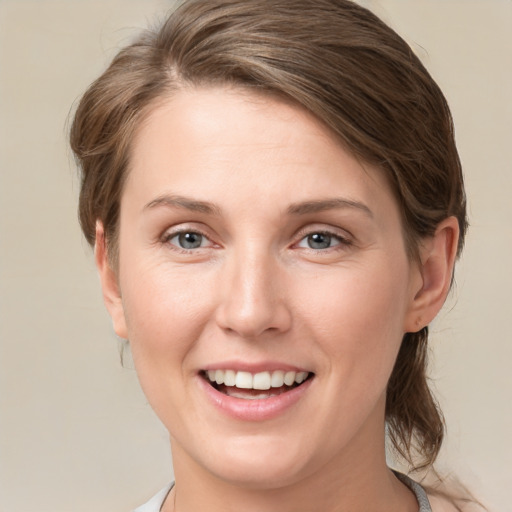 Joyful white young-adult female with medium  brown hair and blue eyes