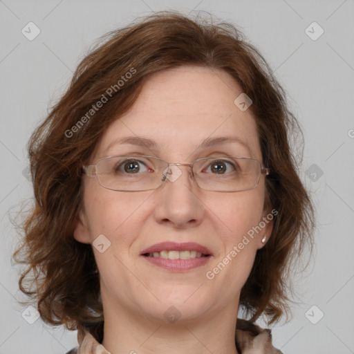 Joyful white adult female with medium  brown hair and green eyes