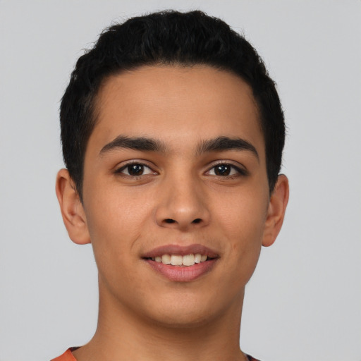 Joyful latino young-adult male with short  brown hair and brown eyes