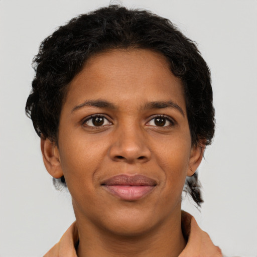 Joyful black young-adult female with short  brown hair and brown eyes