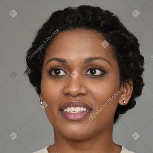 Joyful black young-adult female with short  black hair and brown eyes