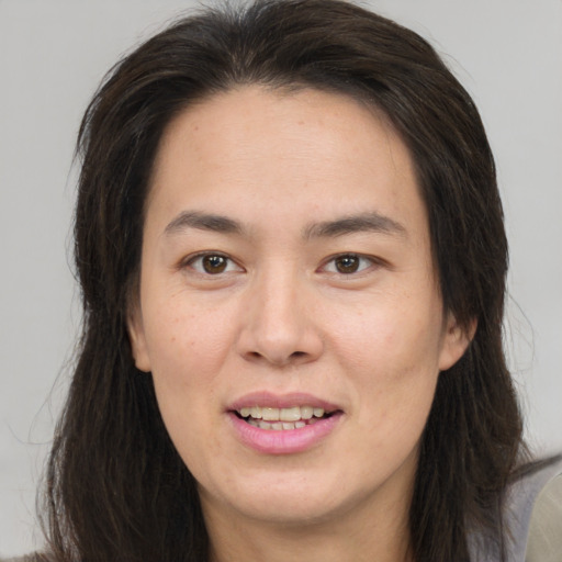 Joyful white young-adult female with long  brown hair and brown eyes
