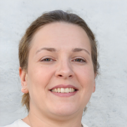 Joyful white young-adult female with short  brown hair and blue eyes