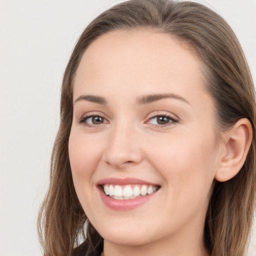 Joyful white young-adult female with long  brown hair and grey eyes