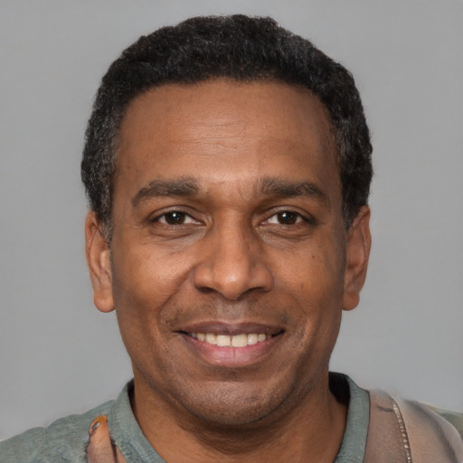 Joyful latino adult male with short  black hair and brown eyes