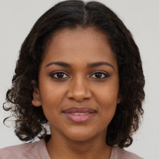 Joyful black young-adult female with medium  brown hair and brown eyes
