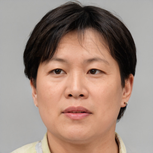 Neutral asian adult female with short  brown hair and brown eyes