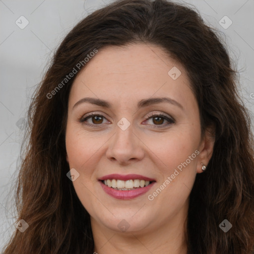 Joyful white adult female with long  brown hair and brown eyes