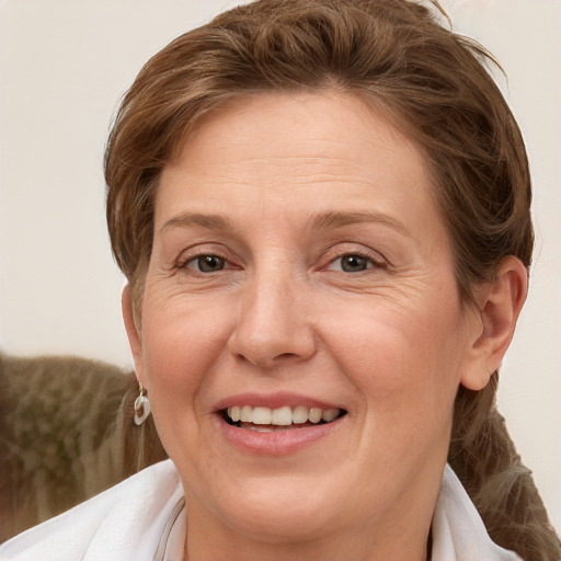 Joyful white adult female with medium  brown hair and grey eyes