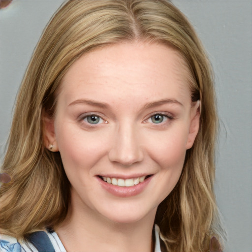 Joyful white young-adult female with medium  brown hair and blue eyes