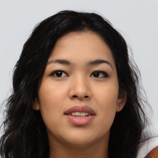 Joyful latino young-adult female with long  black hair and brown eyes