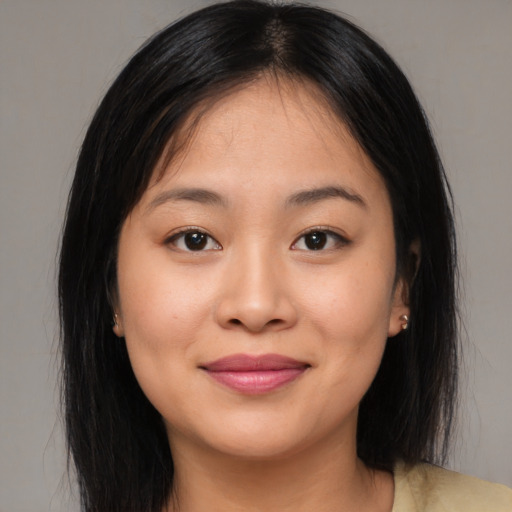 Joyful asian young-adult female with medium  brown hair and brown eyes