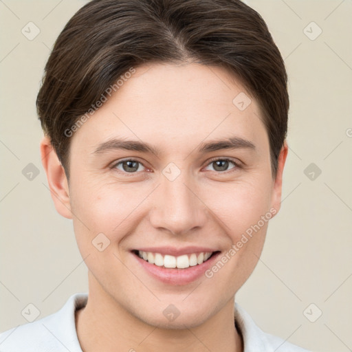 Joyful white young-adult female with short  brown hair and grey eyes