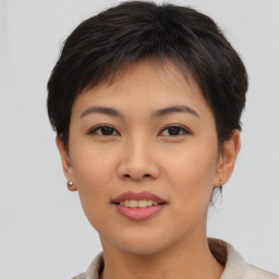 Joyful asian young-adult female with short  brown hair and brown eyes