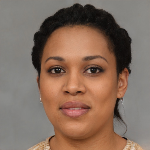 Joyful black young-adult female with short  brown hair and brown eyes