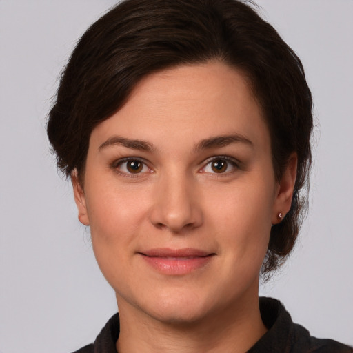 Joyful white young-adult female with medium  brown hair and brown eyes